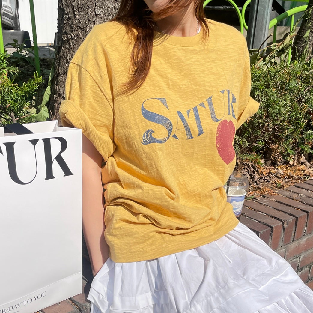 Model wearing SATUR Wave Logo Regular Fit Slub T-Shirt Yellow graphic tee slub fabric vintage casual