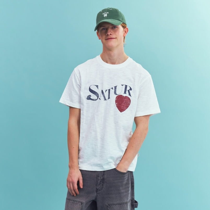 Model wearing SATUR Wave Logo Regular Fit Slub T-Shirt White graphic tee slub fabric vintage casual