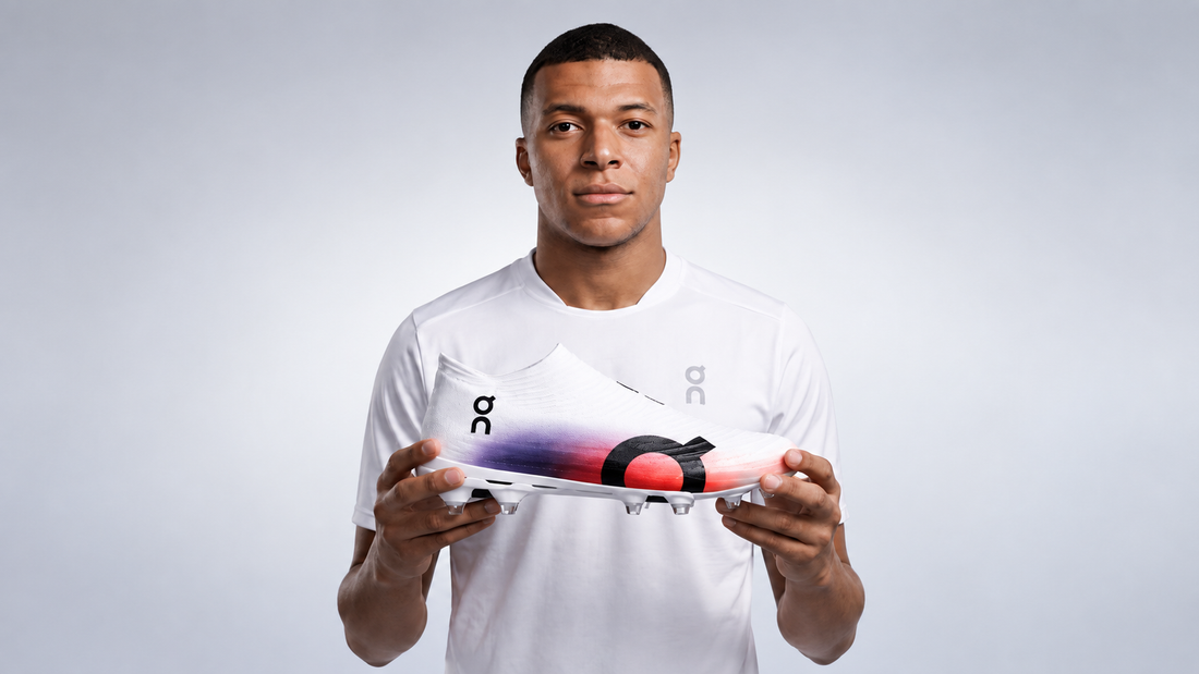 Kylian Mbappé holding the On Cloudboom Strike LS running shoe