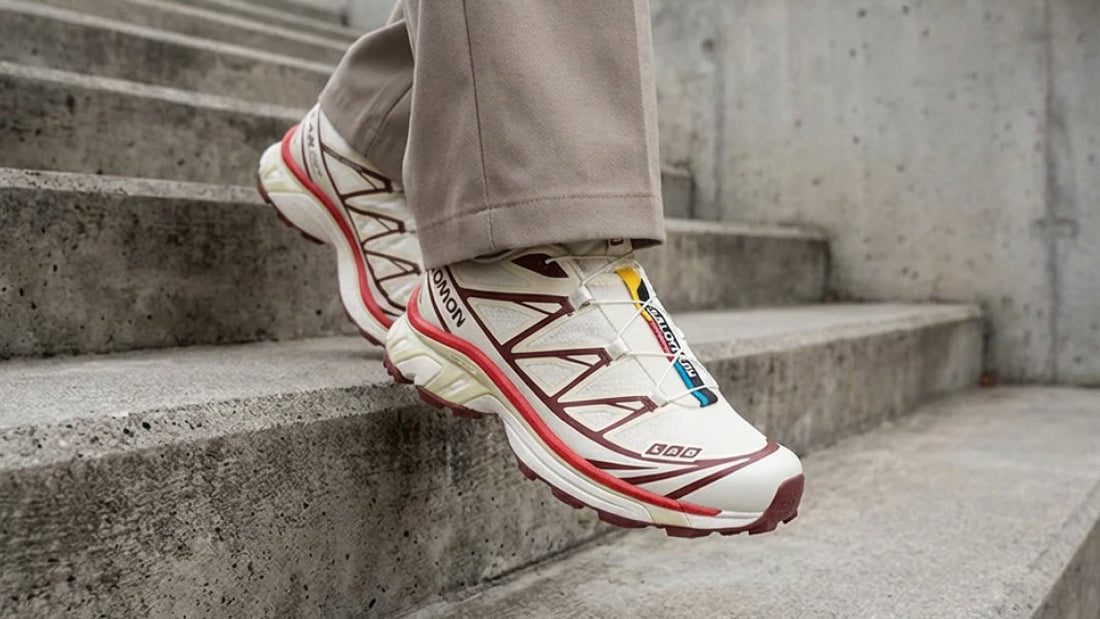 Salomon XT-6 “Vanilla Ice Fired Brick” trail running shoes with Quicklace system, cushioned sole, and durable mesh upper in a cream, grey, and red colourway.