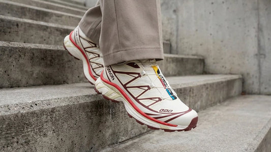 Salomon XT-6 “Vanilla Ice Fired Brick” trail running shoes with Quicklace system, cushioned sole, and durable mesh upper in a cream, grey, and red colourway.
