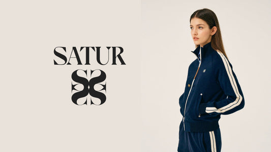 Model wearing the SATUR Essential Lawton Track Zip-Up Jacket in Blue with Lawton All Day Track Shorts in Classic Navy against a neutral studio background.