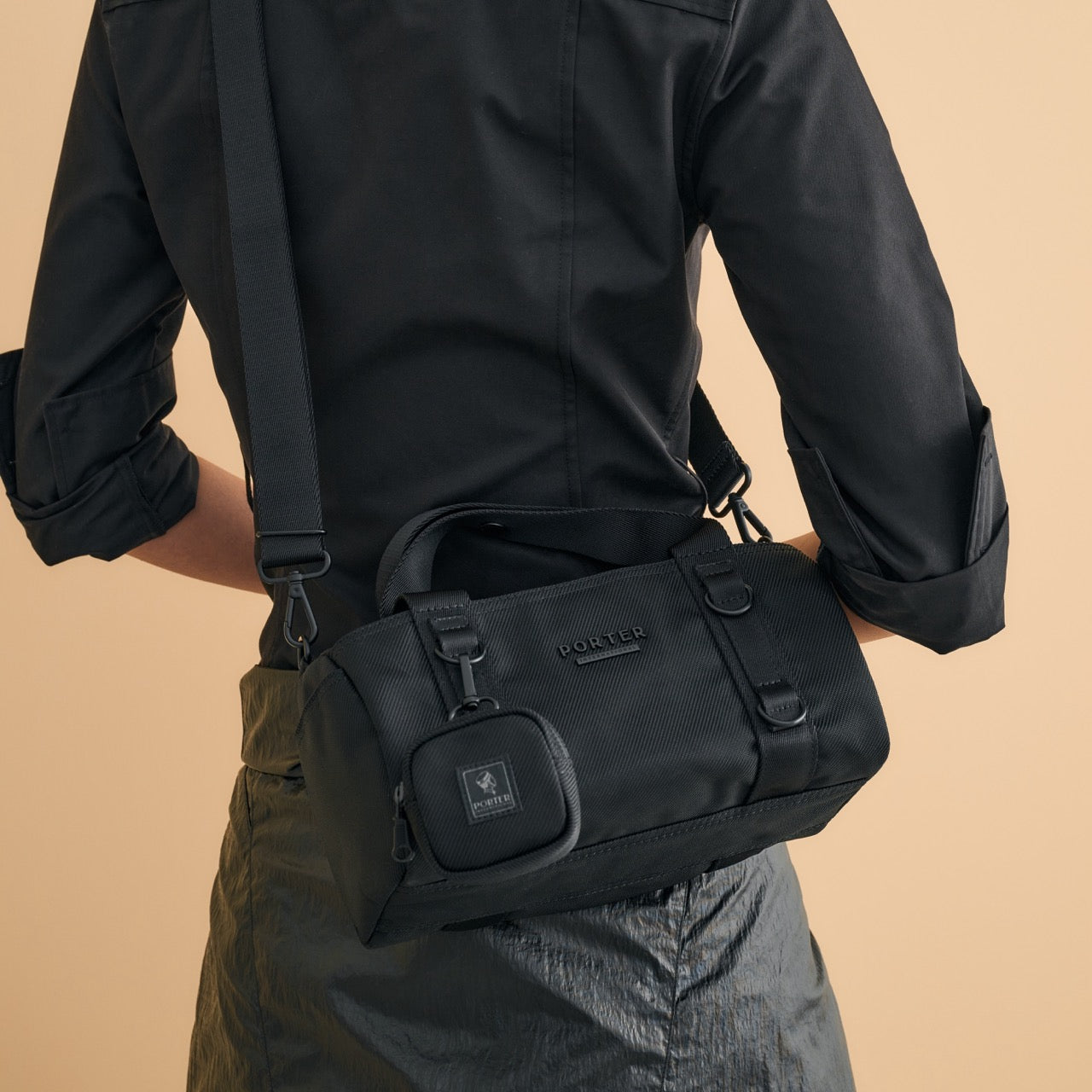 PORTER INTERNATIONAL Rollin Handbag M Black textured nylon shoulder bag cylindrical shape detachable strap mini pouch