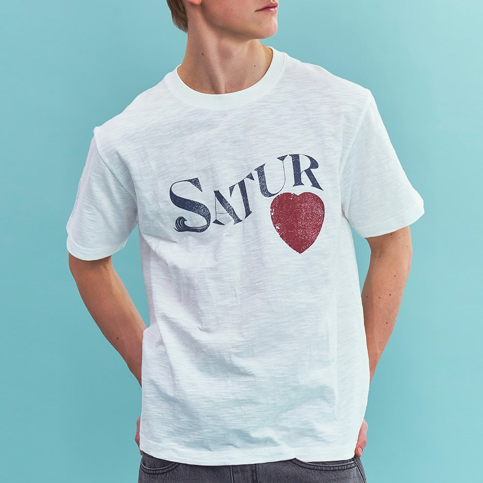 Model wearing SATUR Wave Logo Regular Fit Slub T-Shirt White graphic tee slub fabric vintage casual