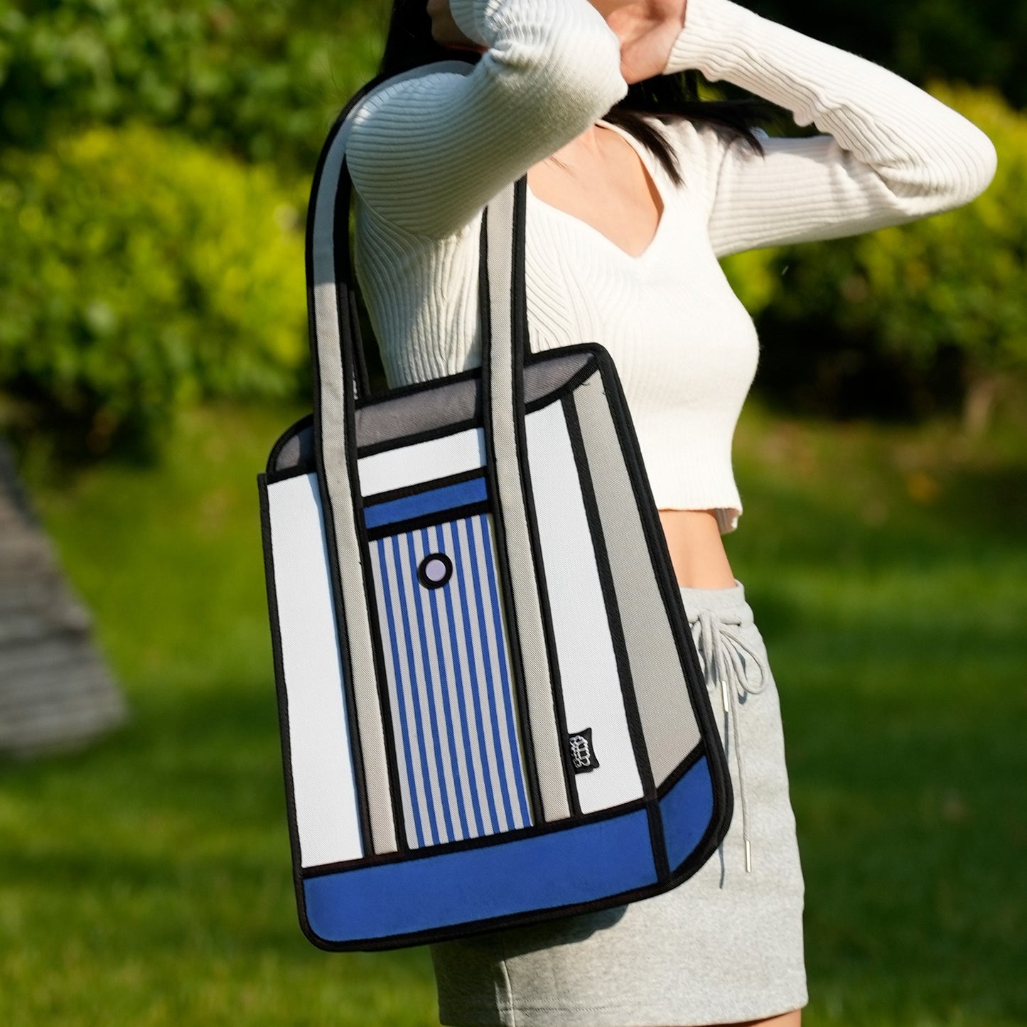 JumpFromPaper Stripe Tote Blue tote bag with cartoon-inspired 2D illusion design blue striped details and shoulder handles