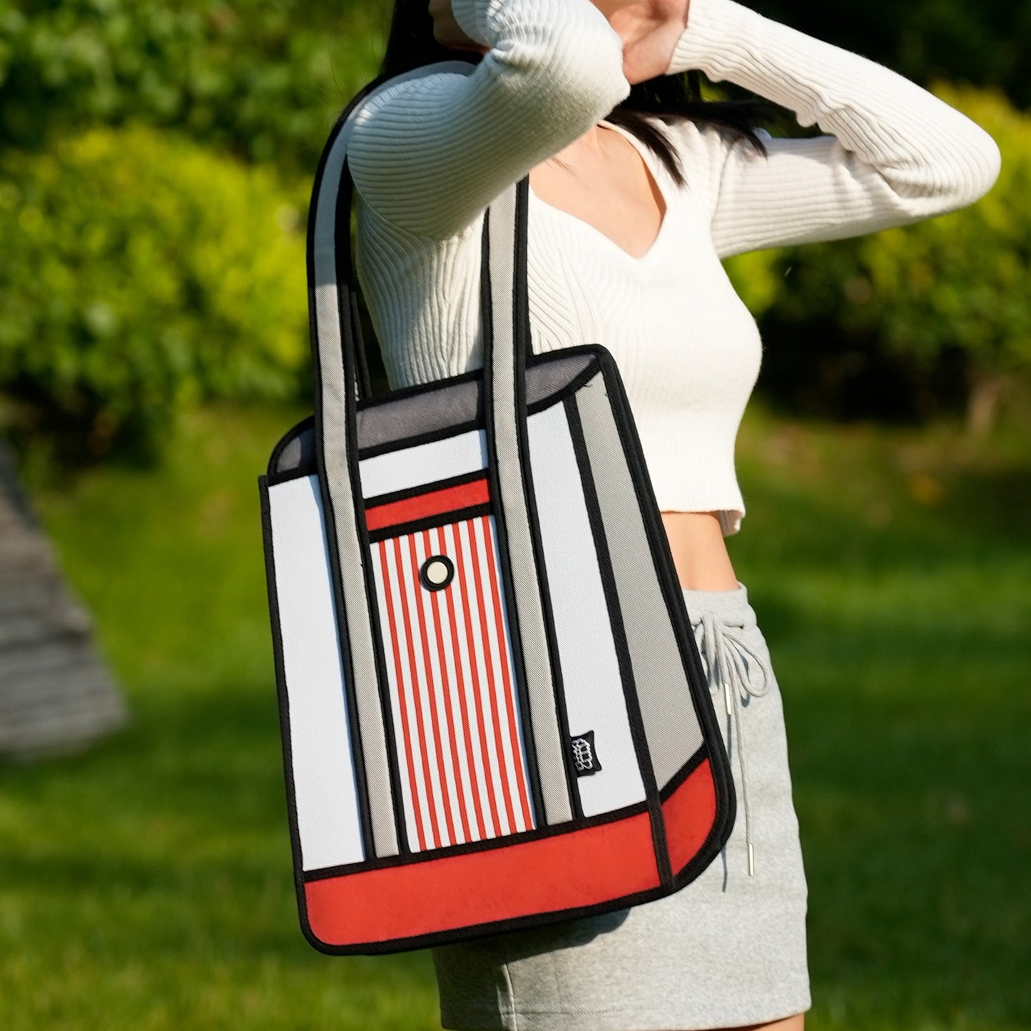 JumpFromPaper Stripe Tote Red tote bag with cartoon-inspired 2D illusion design striped details and shoulder handles