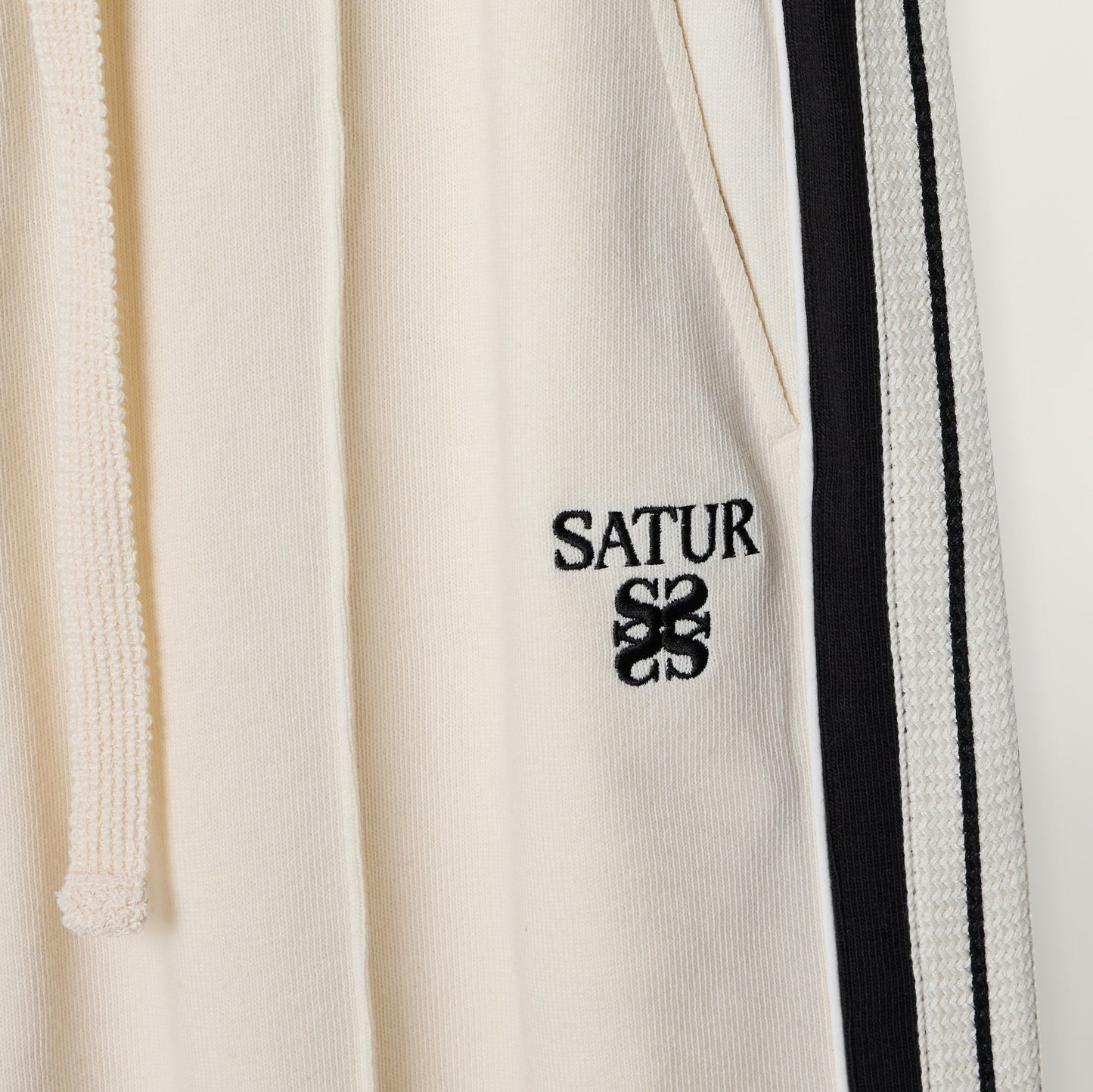 SATUR Lawton Lining Track Pants Cream Black womens lightweight track pants elastic waistband drawstring side stripe casual apparel